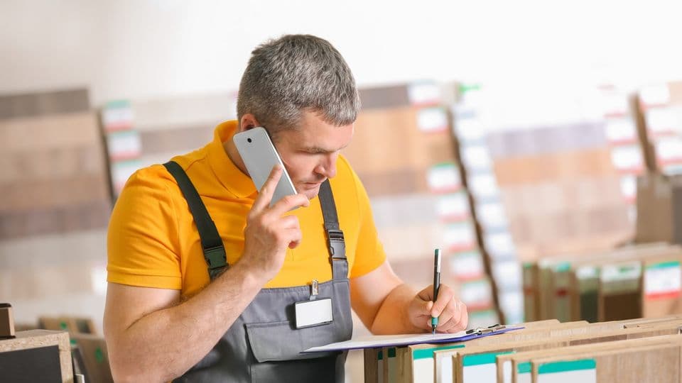 Carpenter talking on phone in hardware store