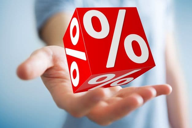 Businessman on blurred background using white and red sales flying icons 3D rendering