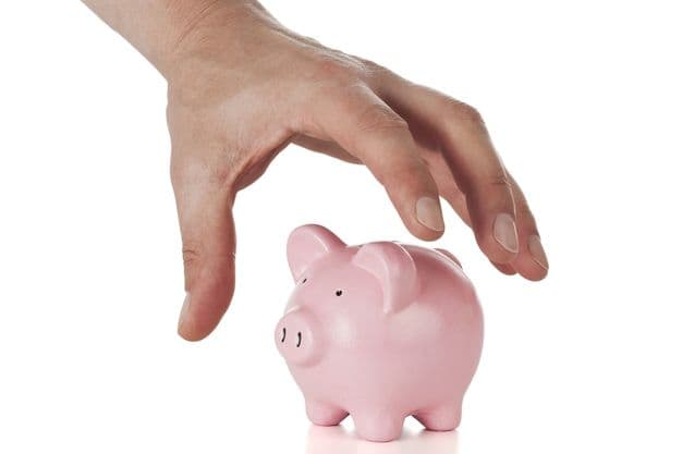 hand grabbing for small piggy bank