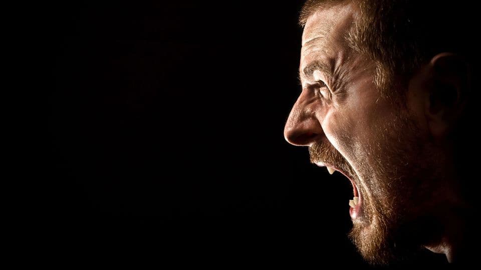 Angry man screaming in extreme rage