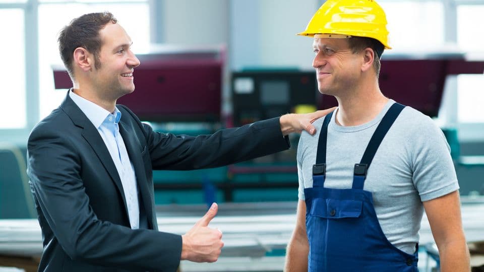 young boss is lauding worker in factory