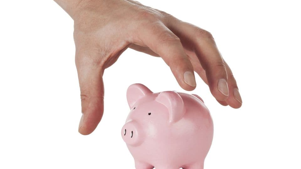 hand grabbing for small piggy bank